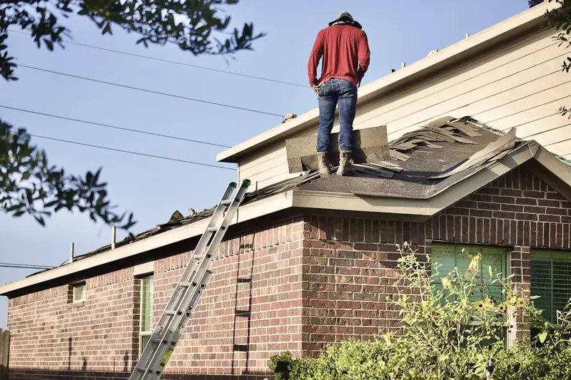 Professional roofer working on a residential roof in Harewood Acres